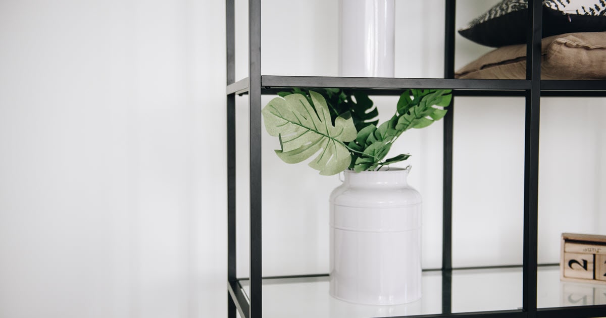 Artificial garden plants on a shelf in this Airbnb holiday home creates a tranquil retreat.