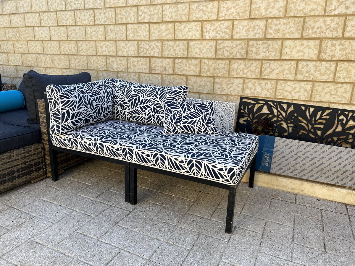 White and black floral patio cushions on unique patio furniture.