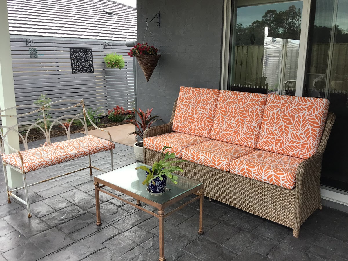 Unique floral pattern patio cushions in orange and white.