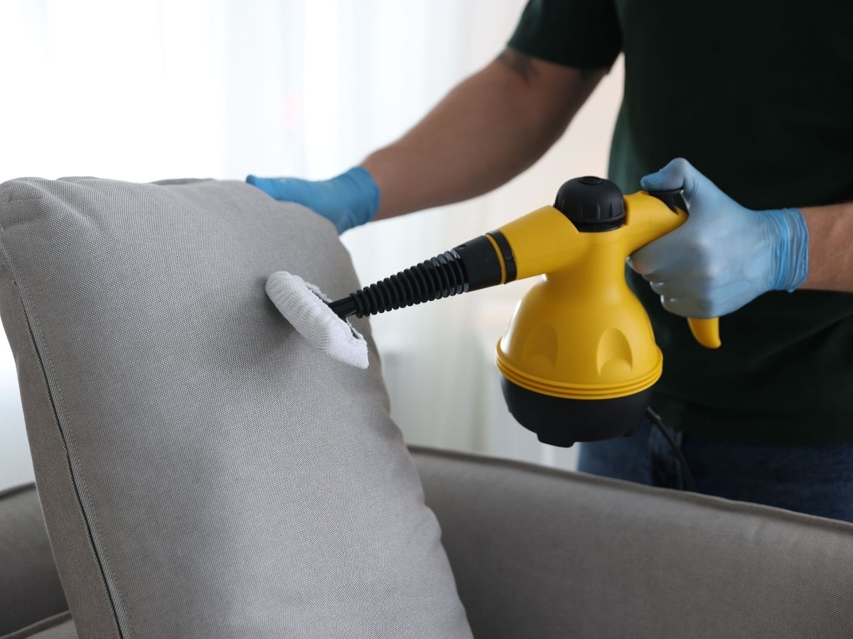 a homeowner cleaning an outdoor cushion